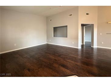 Open living room with hardwood floors and neutral paint scheme provides a modern touch to the space at 1881 W Alexander Rd # 1035, North Las Vegas, NV 89032