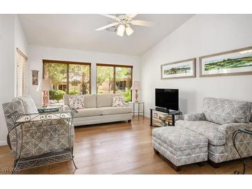 Bright living room with vaulted ceilings, comfortable seating, and large windows at 3128 Faiss Dr, Las Vegas, NV 89134