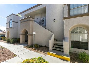 Attractive condo building exterior features stucco walls, arched windows, and a well-maintained landscape at 3150 Soft Breezes Dr # 2030, Las Vegas, NV 89128