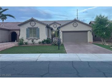 Charming single-story home with a well-manicured lawn and an attached two-car garage in a quiet neighborhood at 3562 Driving Range St, Las Vegas, NV 89122