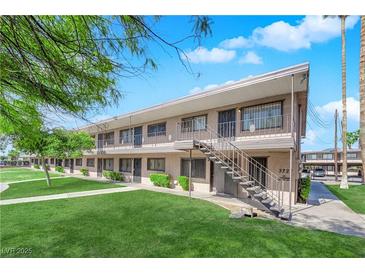 Charming apartment building featuring well-maintained lawns and a stairway leading to the second floor entrance at 3727 Hazelwood St # 12, Las Vegas, NV 89119