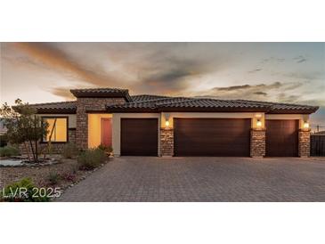 Beautiful single-story home with stone accents, three-car garage, and desert landscaping at 5741 N Park St, Las Vegas, NV 89149