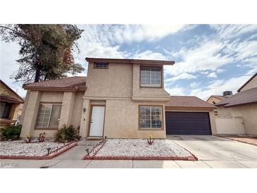 Charming two-story home with stucco siding, tile roof, attached garage, and manicured front yard at 2722 Sweet Basil Dr, Las Vegas, NV 89142