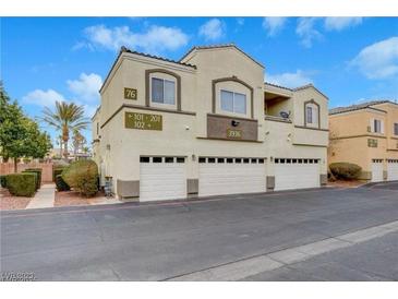 Two-story condo with a three-car garage, desert landscaping, and unit number visible at 3936 Pepper Thorn Ave # 102, North Las Vegas, NV 89081