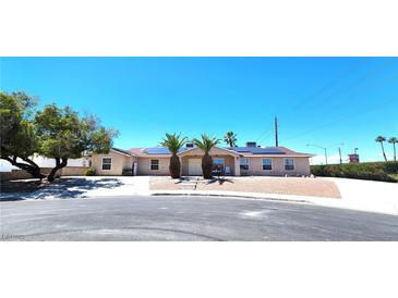 Charming single-story home featuring drought landscaping, a paved driveway, and solar panels on the roof at 4119 Meadowglen Cir, Las Vegas, NV 89121