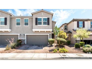 Attractive townhome with a two-car garage and manicured front yard landscaping at 6650 Drusilla St, North Las Vegas, NV 89084