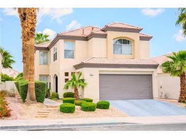 Charming two-story home featuring desert landscaping and a two-car garage at 7840 Millhopper Ave, Las Vegas, NV 89128