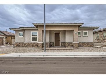 Charming single-story home featuring a brick-accented facade and neutral tones in a well-maintained neighborhood at 790 Sunny Sagebrush St, Henderson, NV 89011