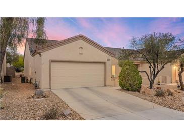 Charming single-story home featuring a neutral color palette, low-maintenance landscaping, and a two-car garage at 7934 Kiskadee St, North Las Vegas, NV 89084