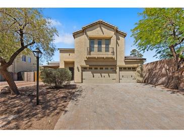 Charming two-story home featuring an attached three-car garage and a beautiful stone-paved driveway at 8029 Chablis Bay St, Las Vegas, NV 89131