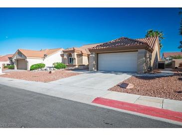 Inviting single story home featuring desert landscaping, tile roof, and a two car garage at 8901 Kingsmill Dr, Las Vegas, NV 89134
