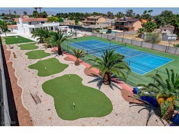Expansive backyard featuring a tennis court and putting green, perfect for outdoor activities and entertaining at , Las Vegas, NV 89146