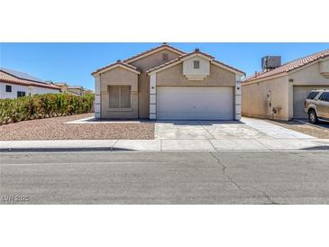 Charming single-story home with a two-car garage and low maintenance landscaping at 1213 Star Meadow Dr, North Las Vegas, NV 89030