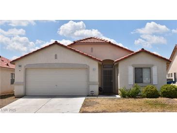 Charming single-story home featuring a red tile roof, neutral stucco, and a two car garage at 343 Dune Ridge Ave, North Las Vegas, NV 89031