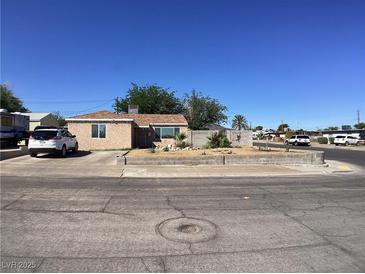 Charming single-story home with well-maintained landscaping and a brick accent wall at 400 National St, Henderson, NV 89015