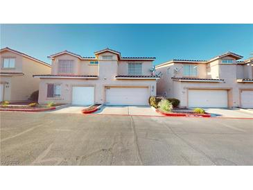 Charming two-story townhouse featuring a one-car garage and well-maintained landscaping at 50 Belle La Blanc Ave, Las Vegas, NV 89123
