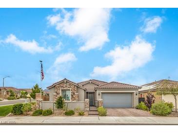 Beautiful single-story home featuring stone accents, a tile roof, a two-car garage, and low-maintenance landscaping at 8257 Skye Peak St, Las Vegas, NV 89166