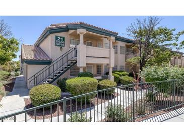 A charming two-story condo complex with lush landscaping and inviting stairways at 8410 Eldora Ave # 1045, Las Vegas, NV 89117