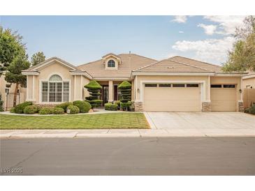 Charming single-story home with a well-manicured lawn, mature trees, and a two-car garage at 1100 Cypress Ridge Ln, Las Vegas, NV 89144