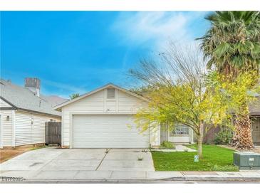 Charming single-story home featuring a two-car garage, well-maintained lawn and mature landscaping at 1574 Teardrop St, Las Vegas, NV 89142