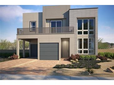 Contemporary two-story home featuring a balcony, two-car garage, modern front door and desert landscaping at 1801 Flycatch St, Las Vegas, NV 89138