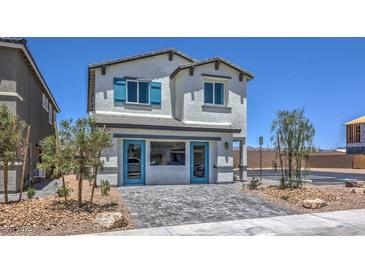 Charming two-story home with a well-maintained lawn and stylish blue accents on windows and doors at 2641 Begonia Falls Ave # 88, North Las Vegas, NV 89081