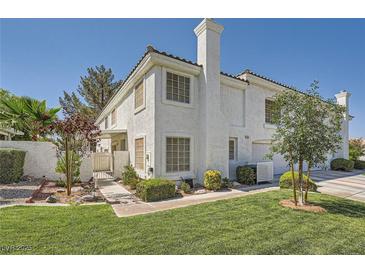 Charming two-story home with a well-manicured lawn and mature landscaping at 2902 Aztec Lily Ln, Henderson, NV 89074