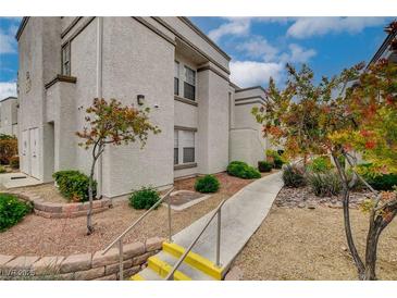 Charming condo featuring a landscaped walkway and steps, offering a welcoming approach to the building's entrance at 3150 Soft Breezes Dr # 2046, Las Vegas, NV 89128