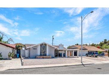 Charming single-story home featuring a low-maintenance gravel yard and covered parking at 4417 Saint Andrews Cir, Las Vegas, NV 89107