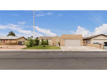 Charming single-story home with a two-car garage, desert landscaping, and inviting curb appeal at 4998 Rappahanock St, Las Vegas, NV 89122