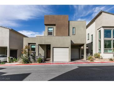 View of the modern house with a two car garage at 649 Tranquil Jade St, Las Vegas, NV 89138