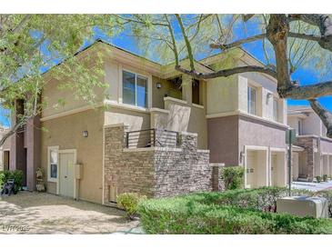 Beautiful two-story condo featuring a stone facade and private balcony at 701 Peachy Canyon Cir # 201, Las Vegas, NV 89144