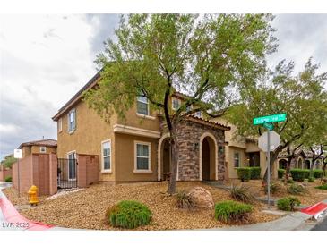 Inviting two-story home featuring a stone-accented entrance and low-maintenance landscaping at 9925 Turquoise Glass Ct, Las Vegas, NV 89178
