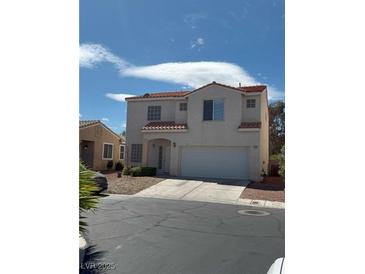 Two-story home featuring a tile roof, stucco exterior, and an attached two-car garage at 1153 Stormy Valley Rd, Las Vegas, NV 89123