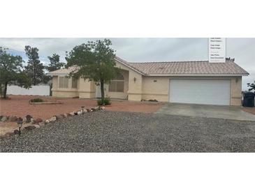 Charming single-story home with a two-car garage and low maintenance desert landscaping at 2431 S Dandelion St, Pahrump, NV 89048