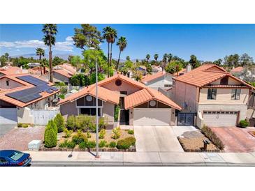 Charming single-Gathering home with a two-car garage, landscaped front yard, and a beautiful terra cotta tile roof at 2704 Miraflores Ave, Las Vegas, NV 89102