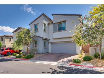Charming two-story home featuring a two-car garage, neat landscaping, and a welcoming facade at 28 Verde Rosa Dr, Henderson, NV 89011