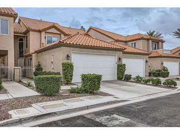 Charming townhome with a two-car garage and manicured landscaping at 3111 Lido Isle Ct, Las Vegas, NV 89117