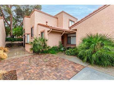 Charming home featuring a stucco exterior, brick paved drive, and desert landscaping at 3246 Brookfield Dr, Las Vegas, NV 89120