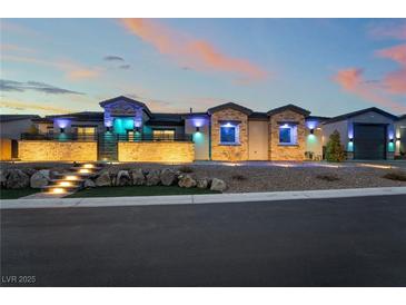 Stunning single-story home exterior with stone accents, lighted stairs, and manicured landscaping at 5865 Alice Landing Ct, Las Vegas, NV 89149