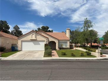 Charming single-story home featuring a well-manicured lawn and a two-car garage, perfect for comfortable living at 9028 Cypress Point Way, Las Vegas, NV 89117