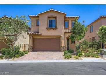 Charming two-story home featuring a two-car garage, stone accents, and professionally landscaped front yard at 12546 Mosticone Way, Las Vegas, NV 89141