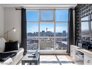 Bright living room featuring large windows with city views, hardwood floors, and modern decor at 150 Las Vegas Blvd # 1608, Las Vegas, NV 89101