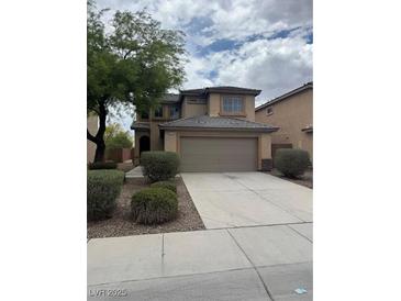 Traditional two-story home with a large driveway and a well-maintained front yard at 3748 Autumn King Ave, Henderson, NV 89052