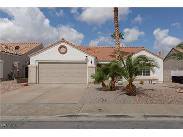 Charming single-story home featuring a two-car garage, desert landscaping, and a classic terra cotta roof at 517 Scenic Terra Dr, Henderson, NV 89015