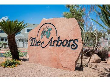 A large stone sign for The Arbors community, surrounded by desert landscaping and blue skies at 5516 Orchard Ln # 0, Las Vegas, NV 89110