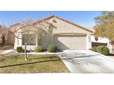 Single story home featuring desert landscaping, an attached two car garage, and neutral paint at 7755 Pacific Rim Ct, Las Vegas, NV 89139