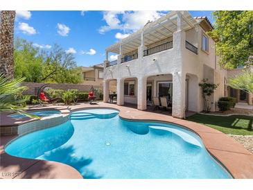 Inviting backyard with a pool and a beautiful two-story house at 820 Colina Alta Pl, Las Vegas, NV 89138