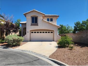 Charming two-story home with a two-car garage and well-maintained landscaping at 10400 Beachwalk Pl, Las Vegas, NV 89144