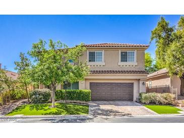 Charming two-story home boasts a well-maintained lawn and a spacious two-car garage at 11219 Playa Bonita Ave, Las Vegas, NV 89138